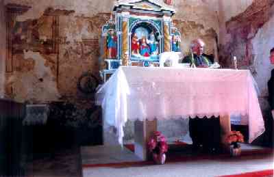 Priest giving mass at Sveti Duh... fresco can be seen behind him.